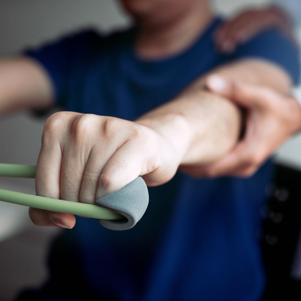 Physical therapist providing hands-on pain and injury rehabilitation