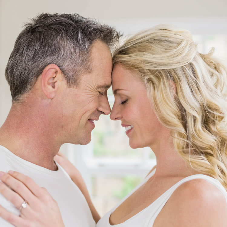 Couple embracing, foreheads touching