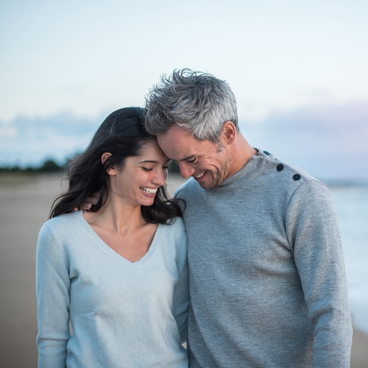 Couple laughing together on the beach