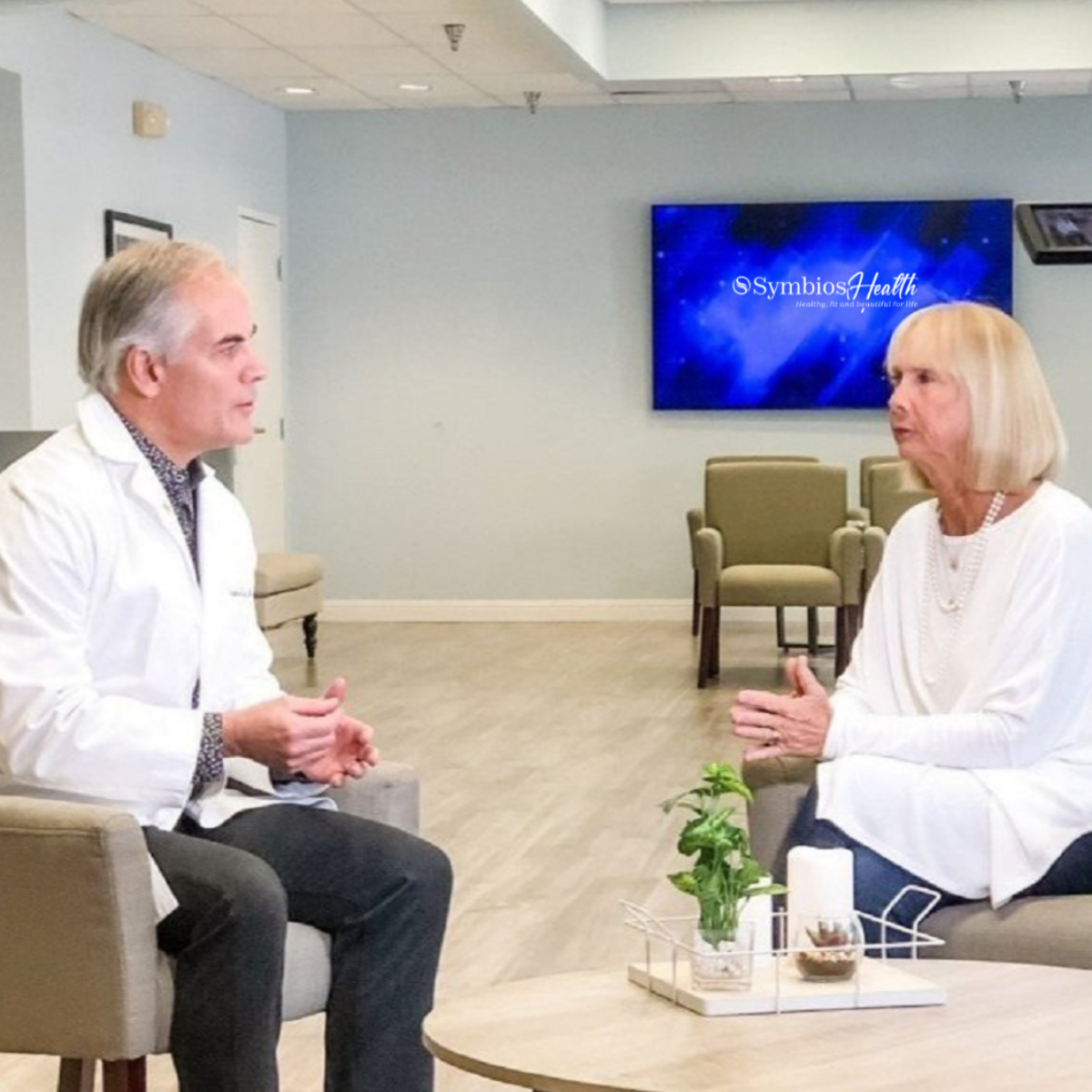 Dr. Stephan Luther consulting with a patient at Symbios Health in Hilton Head Island, SC